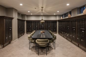 Mail room with dark wood mailboxes and seating area